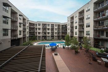 Apartment complex with a pool in the middle.